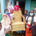 Women holding bamboo chair